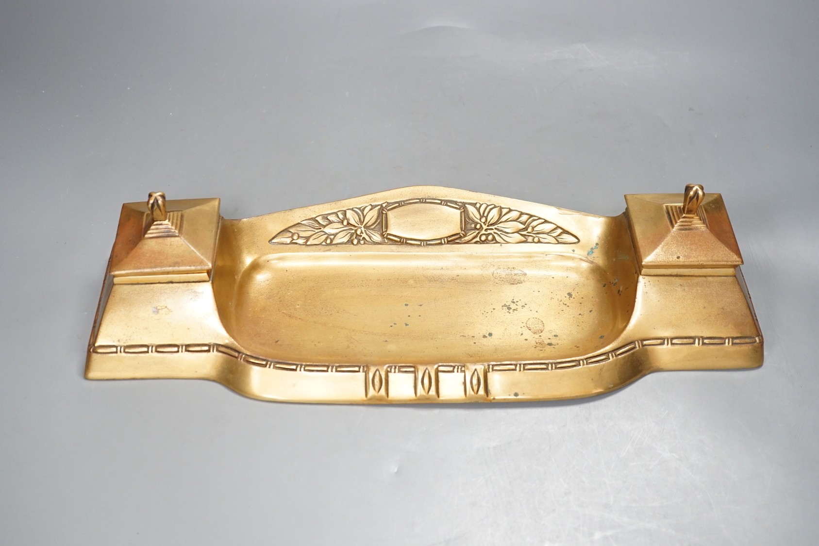 An Arts & Crafts style brass desk stand - 40cm wide